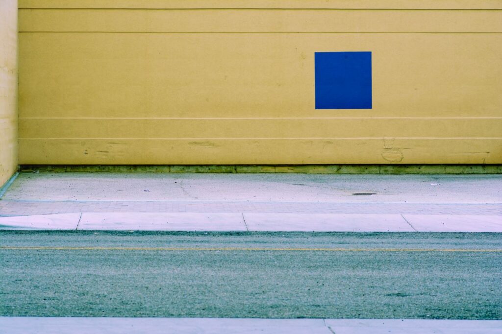 pexels photo 19504257 19504257 A geometric wall with a blue square in a minimalistic urban street setting, offering creative copyspace.